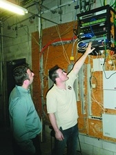 After replacing the existing DVRs with encoders in the data closets throughout the shopping center, Robert Tabbara (left) and Brian Heldreth of 911 Security review the transition plan to clean up the temporary wiring without causing any system downtime.