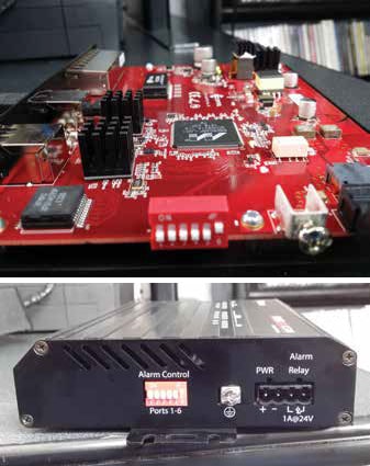 All components, including the top panel LEDs, are on a single circuit board (top). Fit and finish are a little sloppy, with the power connector poorly centered in the chassis (bottom).